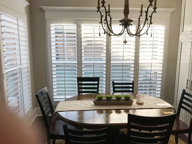 Plantation shutters in a furnished dining nook