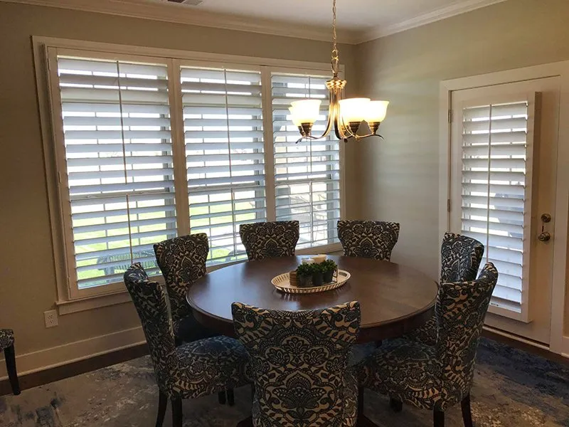 Plantation shutters across dining room windows