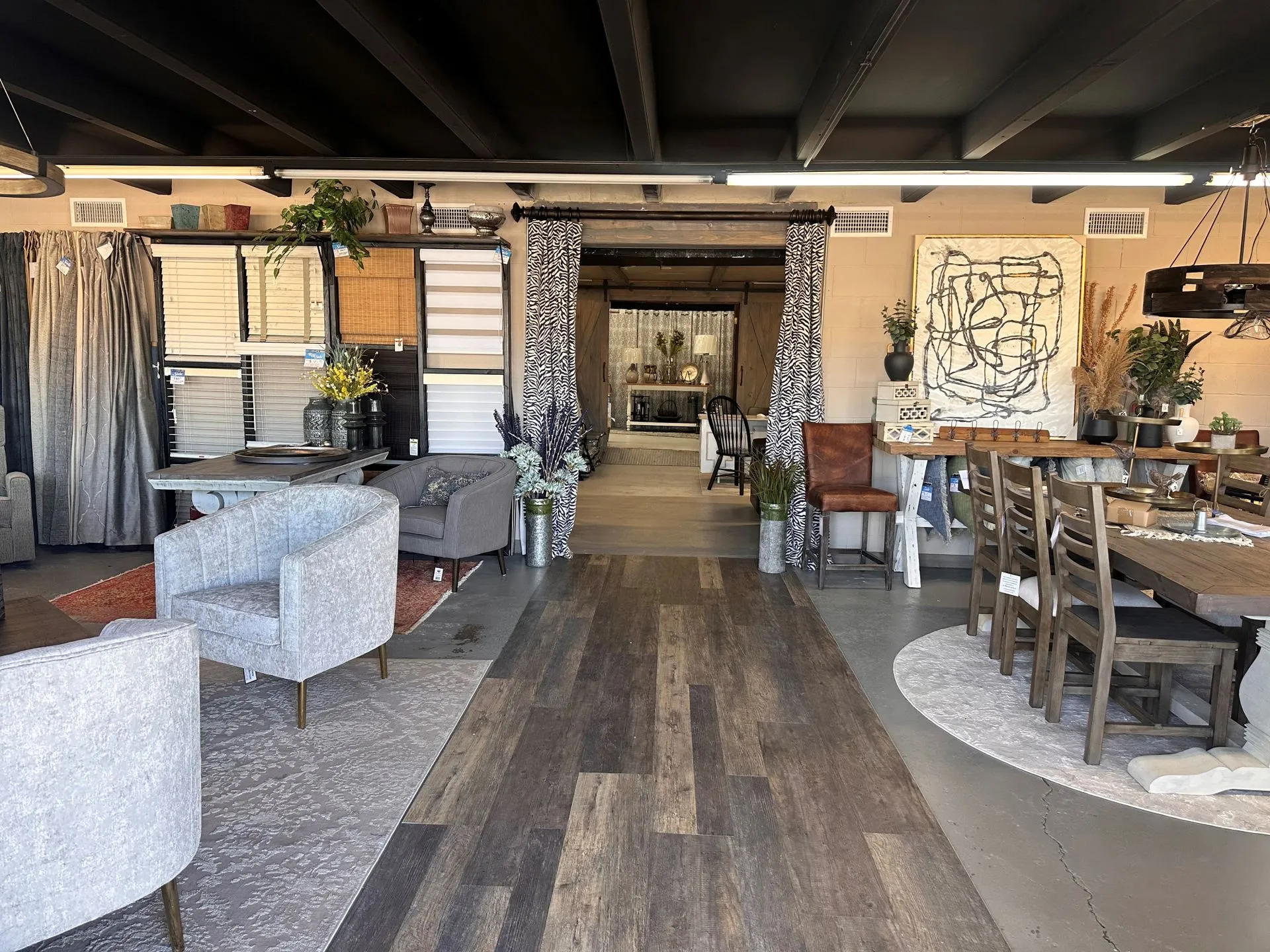 BlueHouse showroom with window treatments, rugs, dining, and furnishings